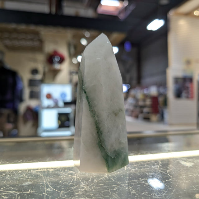 Crystal on a counter with a blurred store interior in the background