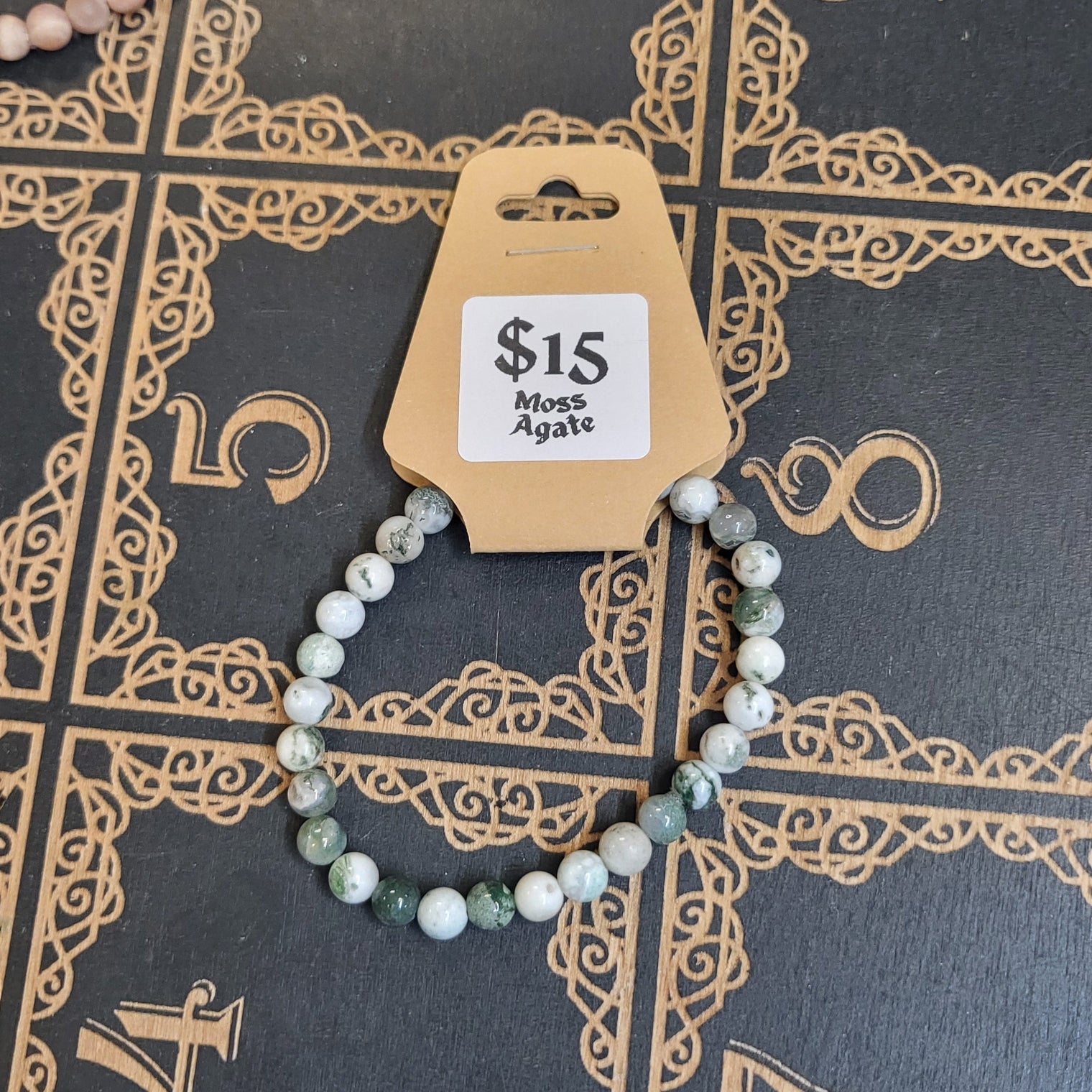 Bracelet with a price tag on a decorative black surface