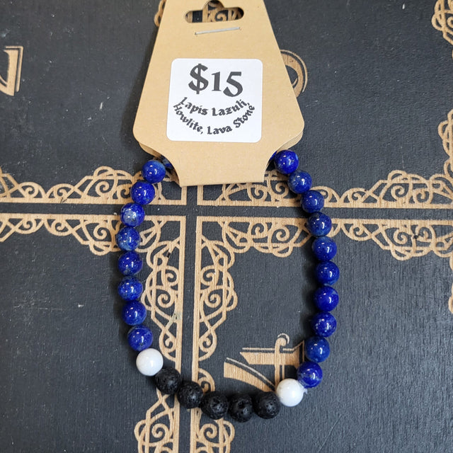Bracelet with blue and black beads on a decorative book