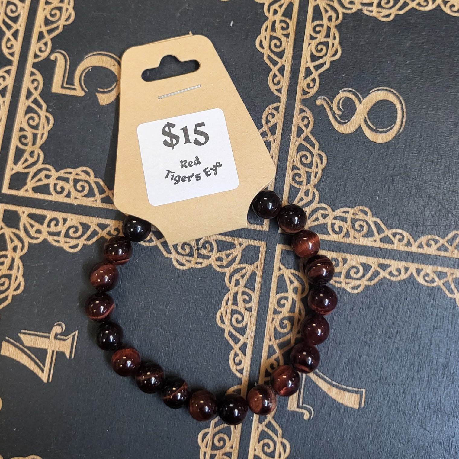 Bracelet with a price tag on a decorative black and gold background