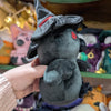 Plush crow doll named "Ascrowdeus", viewed from the sidd. Doll is overall black except for red eyes. It has plush beak, wings, feet, tail, and feather beard with embroidered detail, all of which is black. It also has a black witch's hat with red hat band.