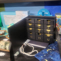 Black advent calendar with gold numbers on a blue surface with tarot card designs.