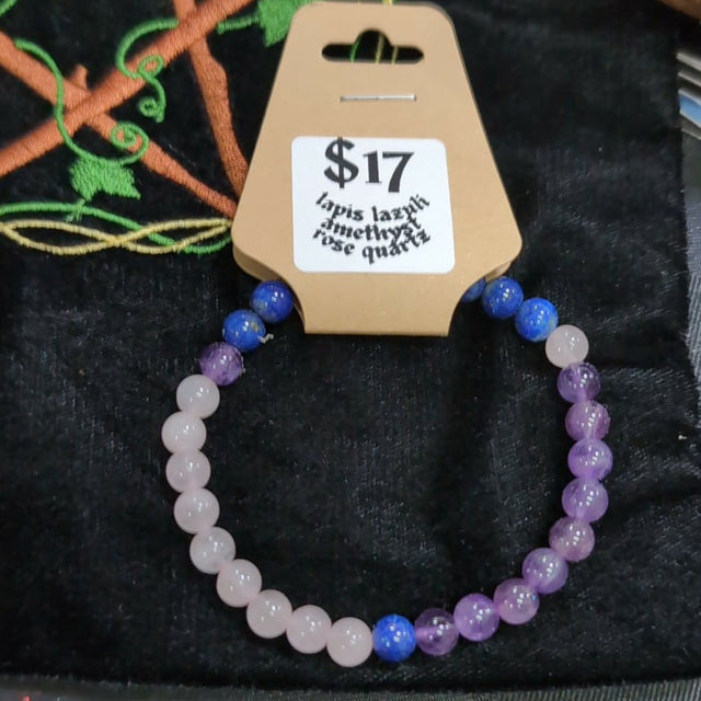 Beaded bracelet on a black surface with a price tag attached