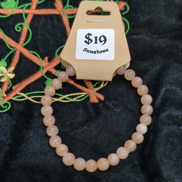 Beaded bracelet on a black surface with a price tag indicating $19.