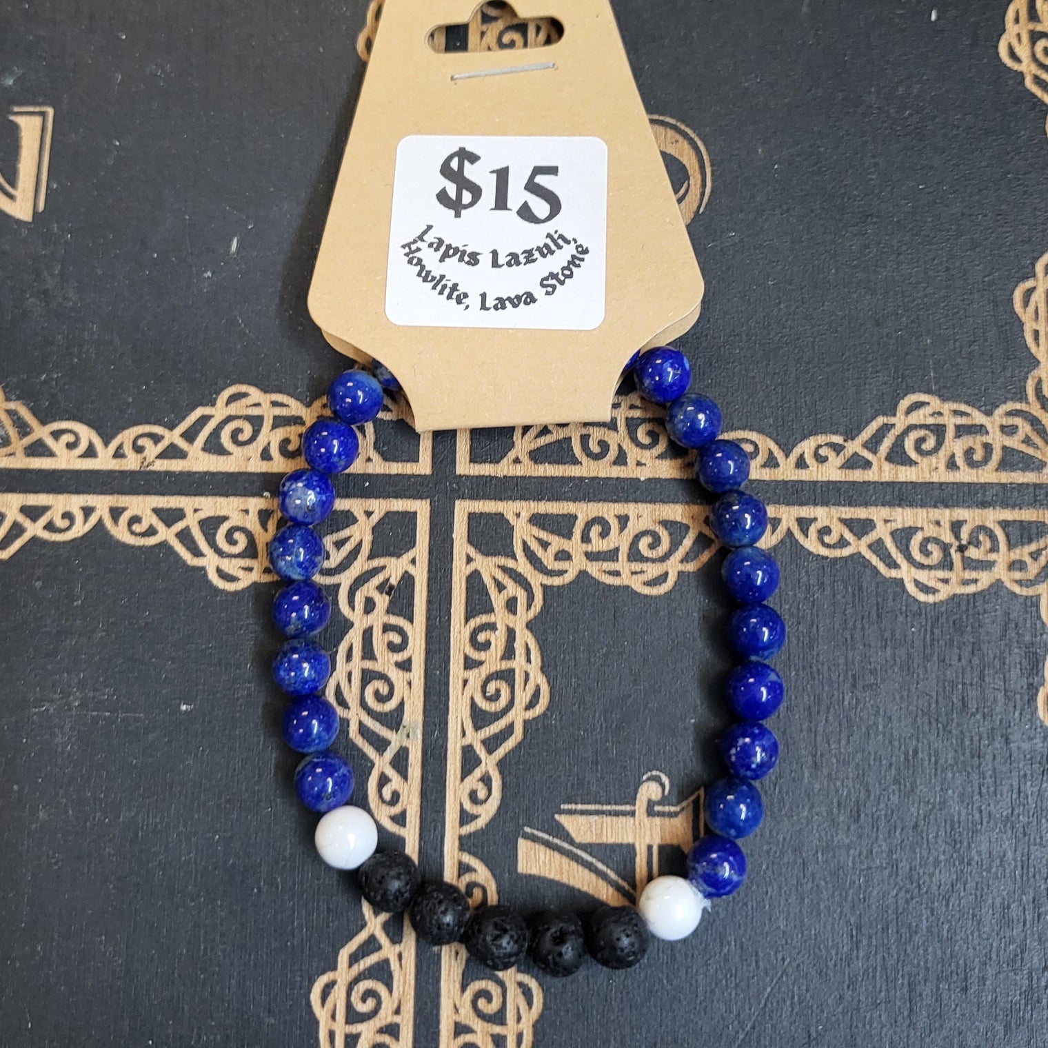 Bracelet with blue and black beads on a decorative book