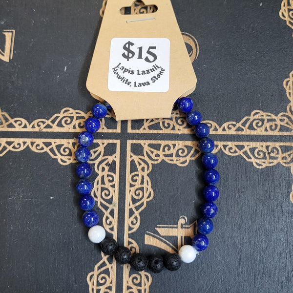 Bracelet with blue and black beads on a decorative book